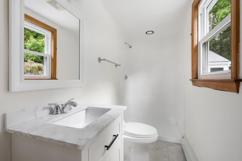 a white toilet sitting next to a bathroom sink
