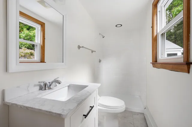 a white toilet sitting next to a bathroom sink