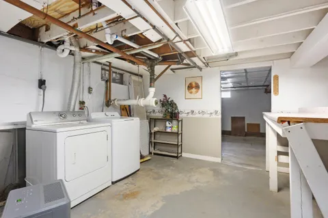 a utility room with cabinets dryer and washer