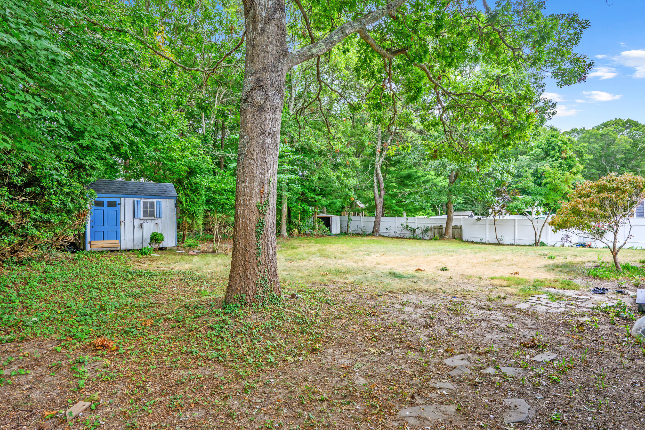 296 Buckskin Path Centerville, MA 02632 - Photo 25 of 34 a view of a house with backyard and trees