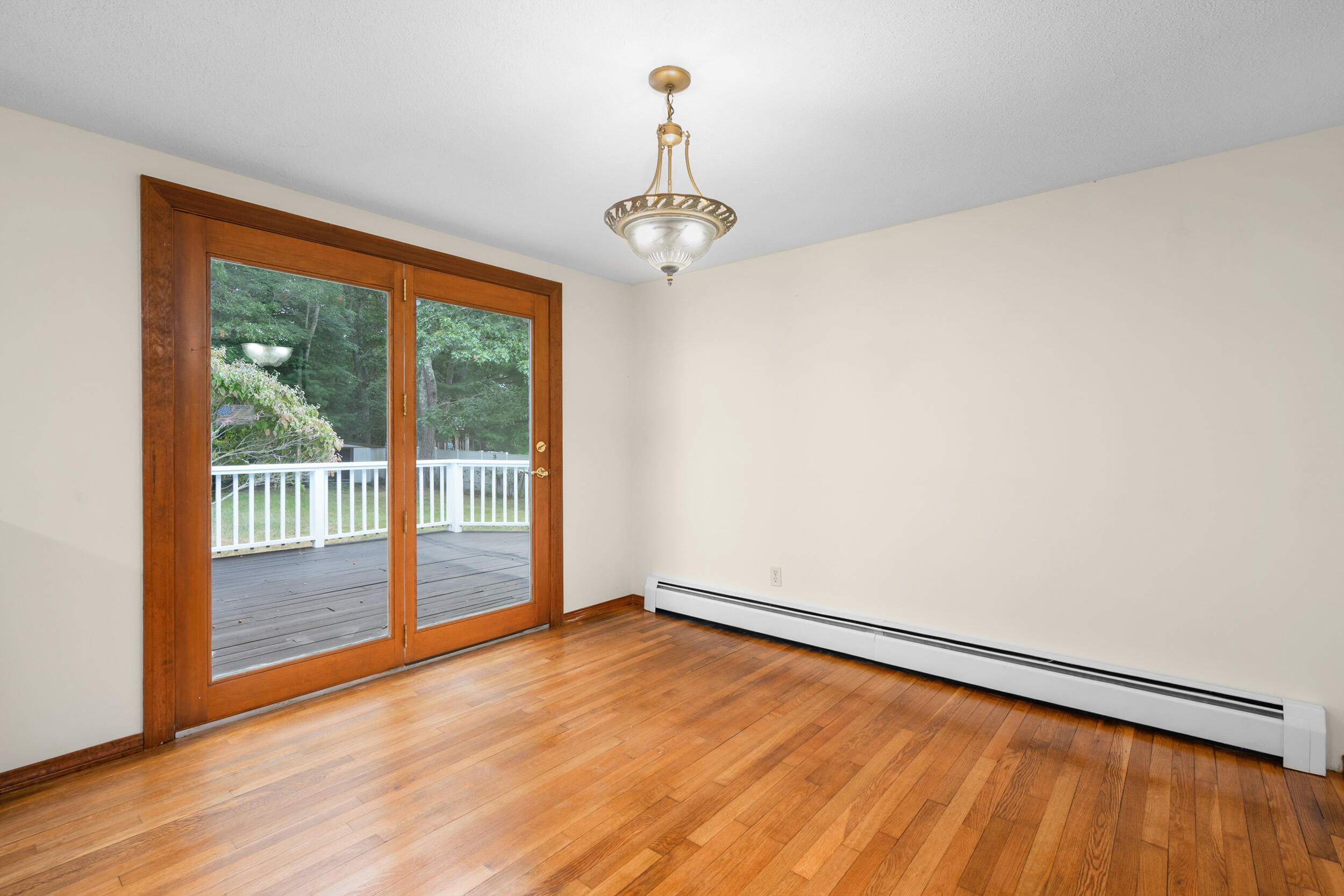 296 Buckskin Path Centerville, MA 02632 - Photo 5 of 34 a view of an empty room with wooden floor and a window