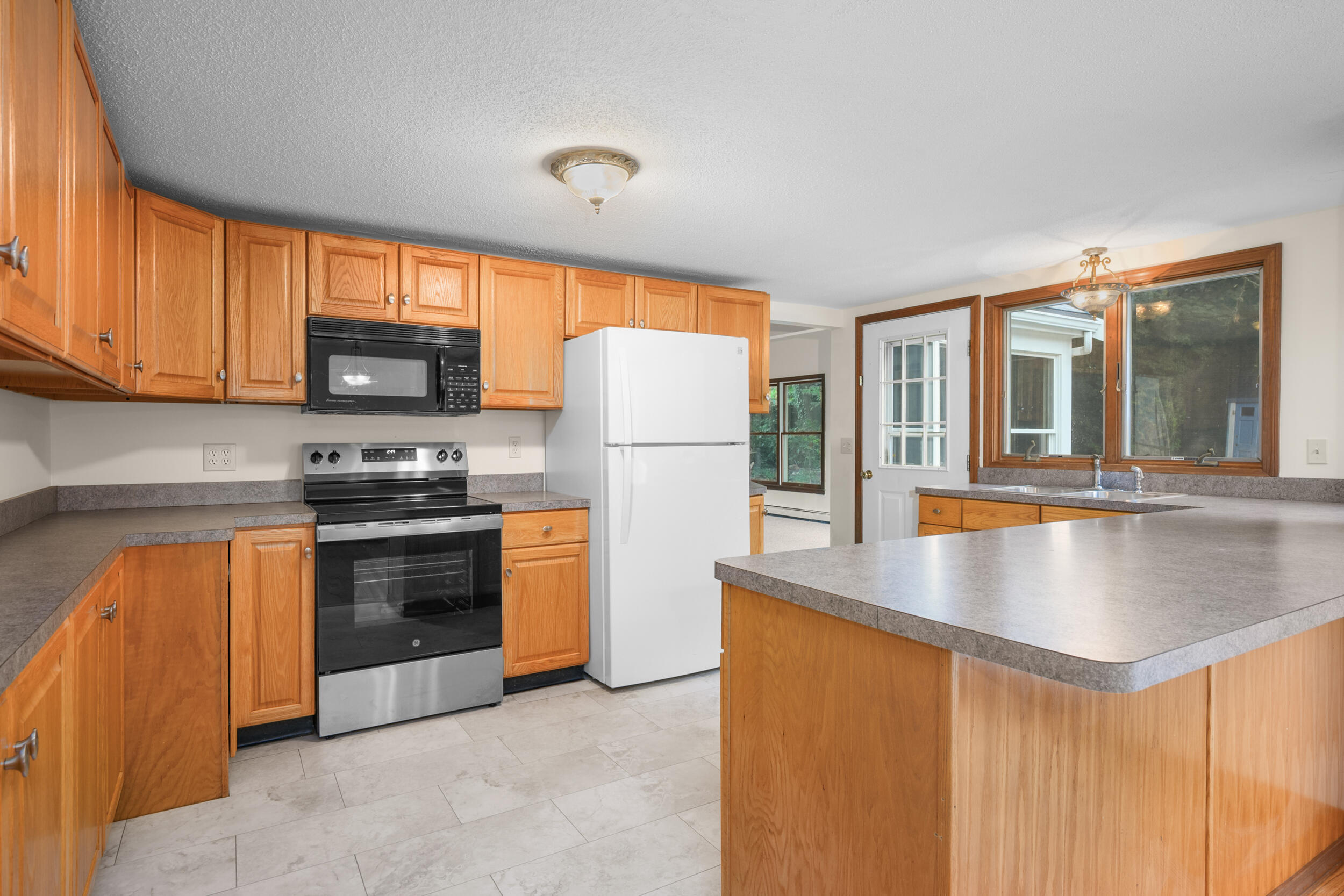 296 Buckskin Path Centerville, MA 02632 - Photo 6 of 34 a kitchen with stainless steel appliances granite countertop a refrigerator stove top oven a sink and dishwasher
