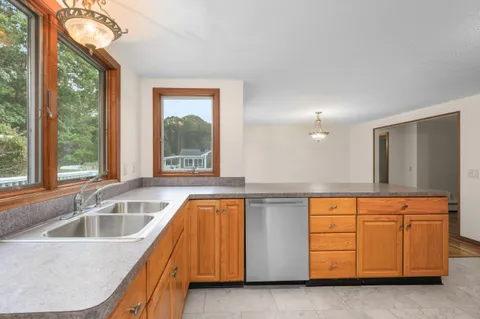 a kitchen with a sink and a large window