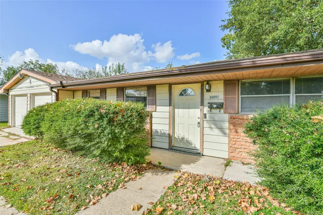 front view of a house with a garden