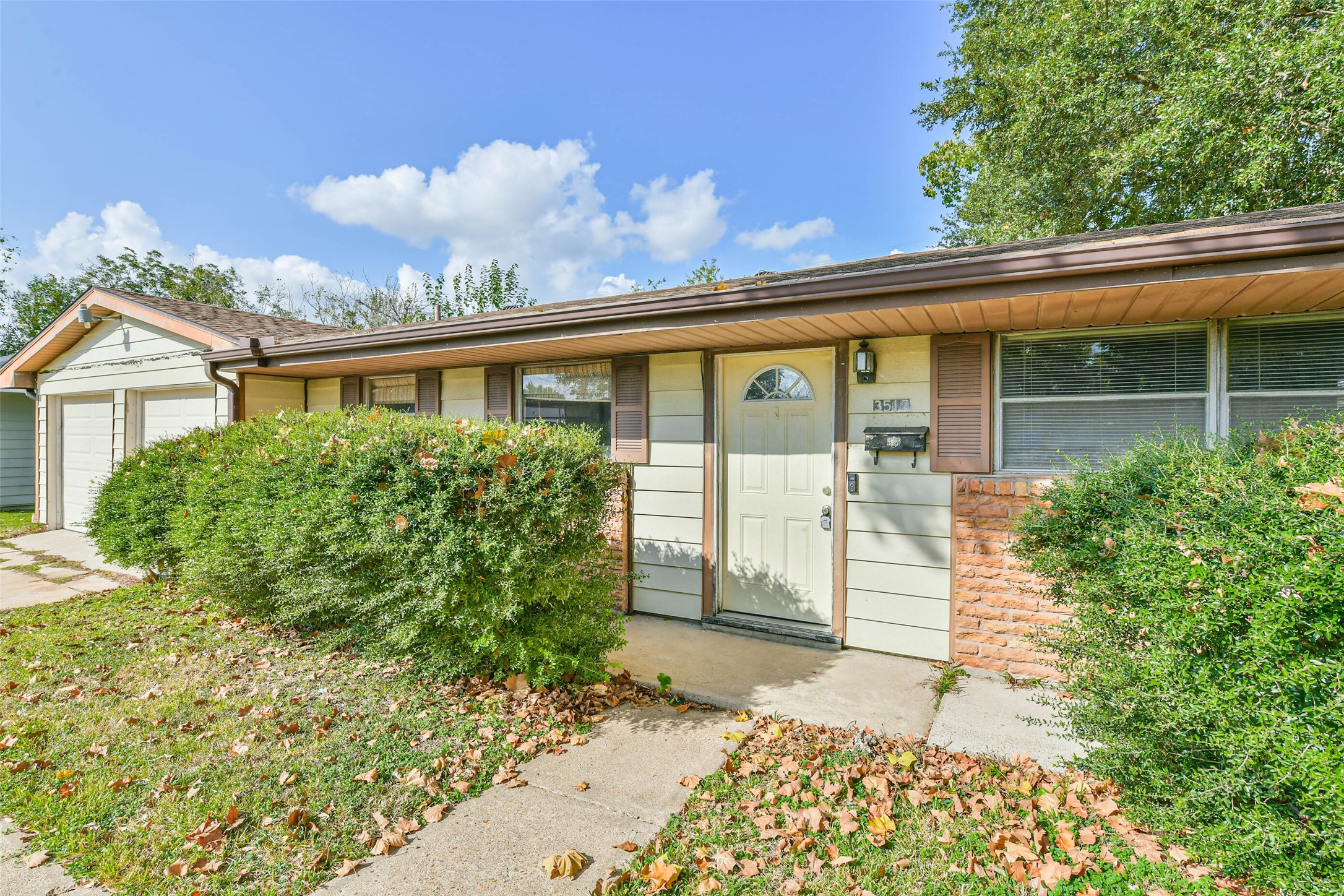 front view of a house with a garden
