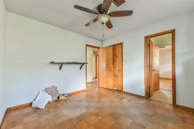 a view of a room with a ceiling fan