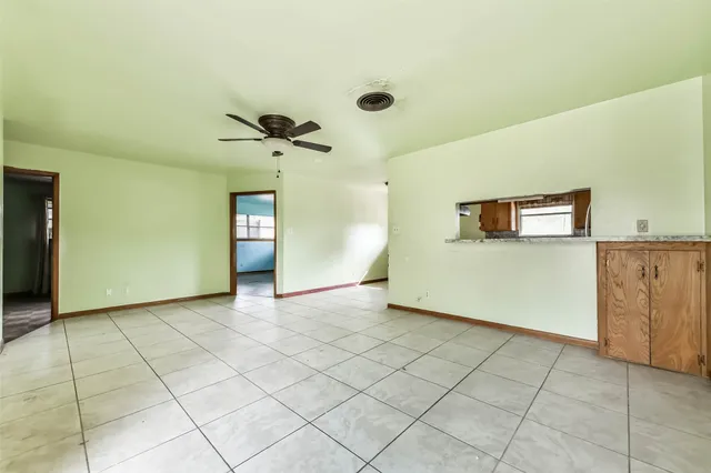 a view of a kitchen with cabinets and a stove top oven