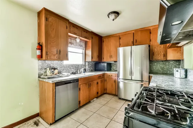 a kitchen with a refrigerator and a sink