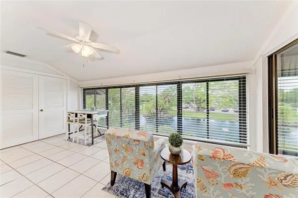 a living room with furniture and large windows