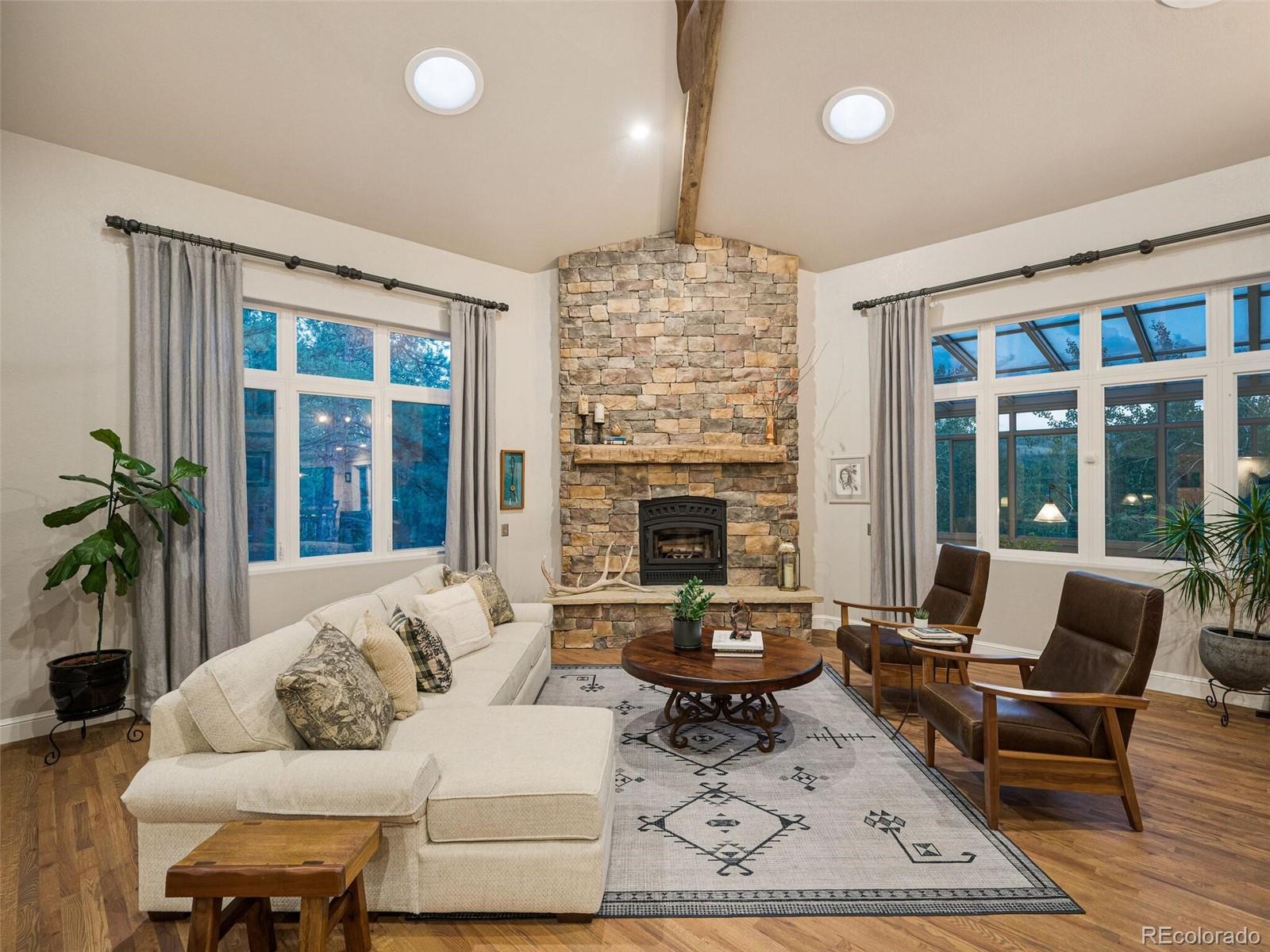 137 Nuthatch Road Evergreen, CO 80439 - Photo 11 of 50 a living room with furniture a rug and a fireplace