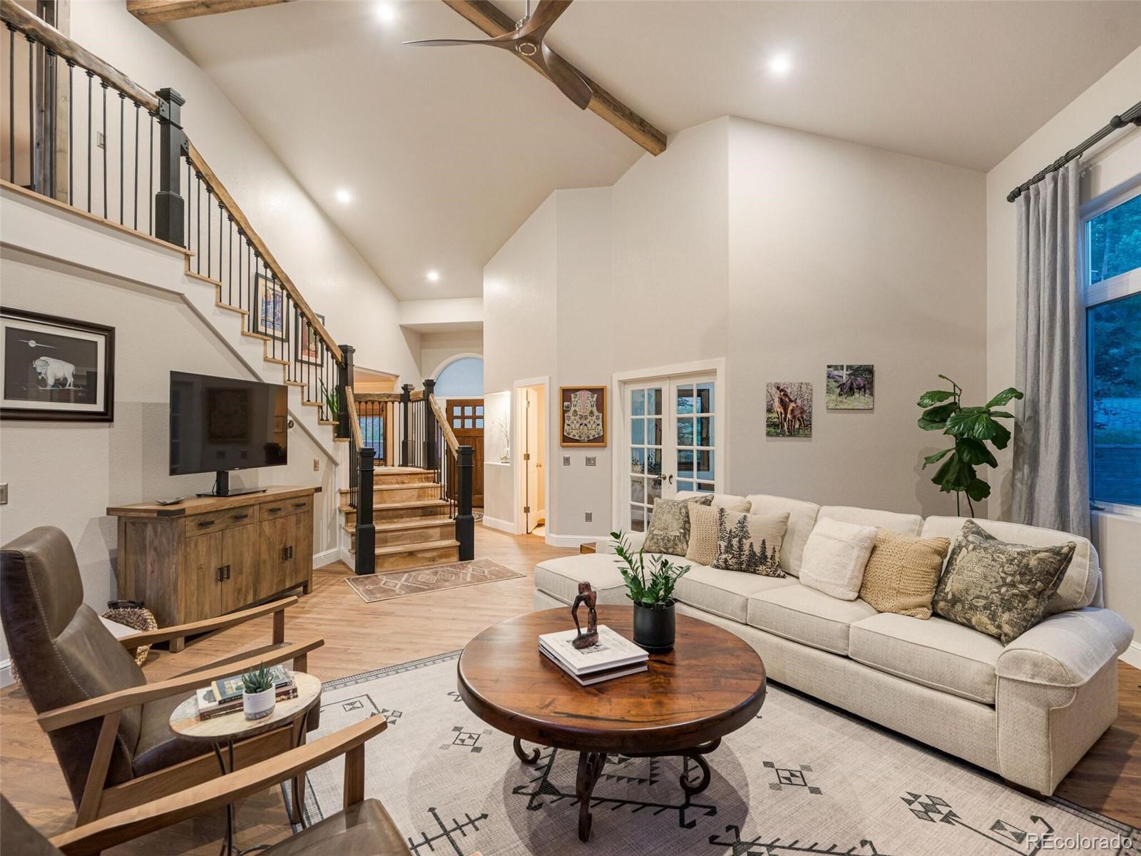 137 Nuthatch Road Evergreen, CO 80439 - Photo 12 of 50 a living room with furniture a flat screen tv and kitchen view