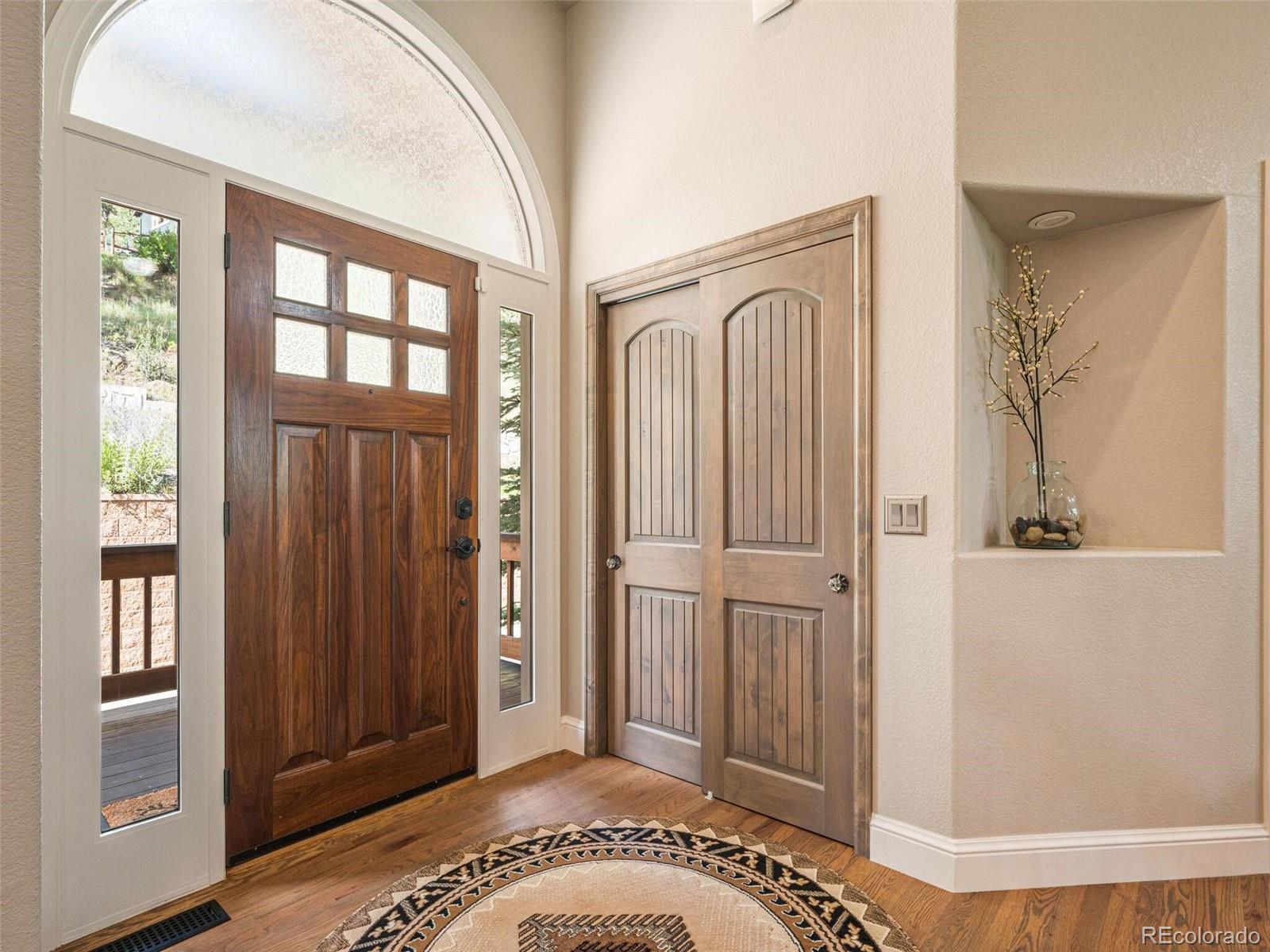 137 Nuthatch Road Evergreen, CO 80439 - Photo 13 of 50 a view of a hallway with windows and stairs