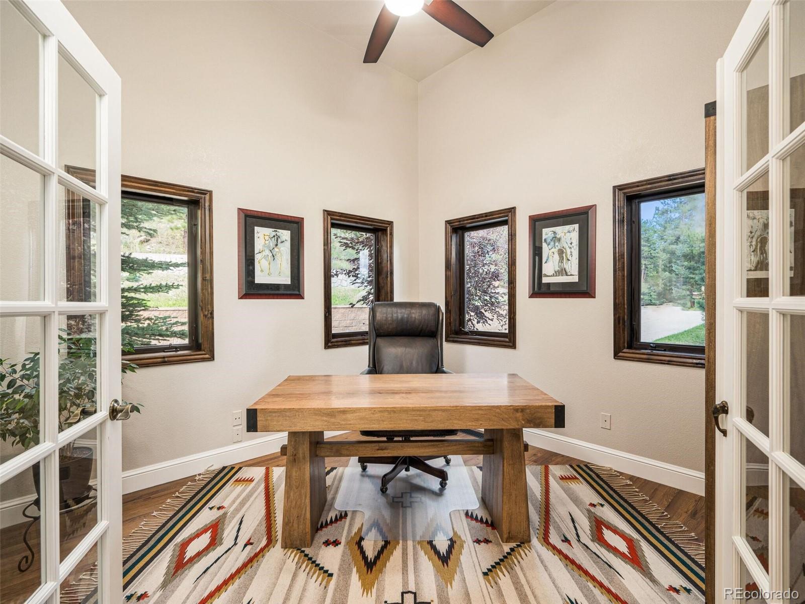 137 Nuthatch Road Evergreen, CO 80439 - Photo 14 of 50 a view of a dining room with furniture and a window