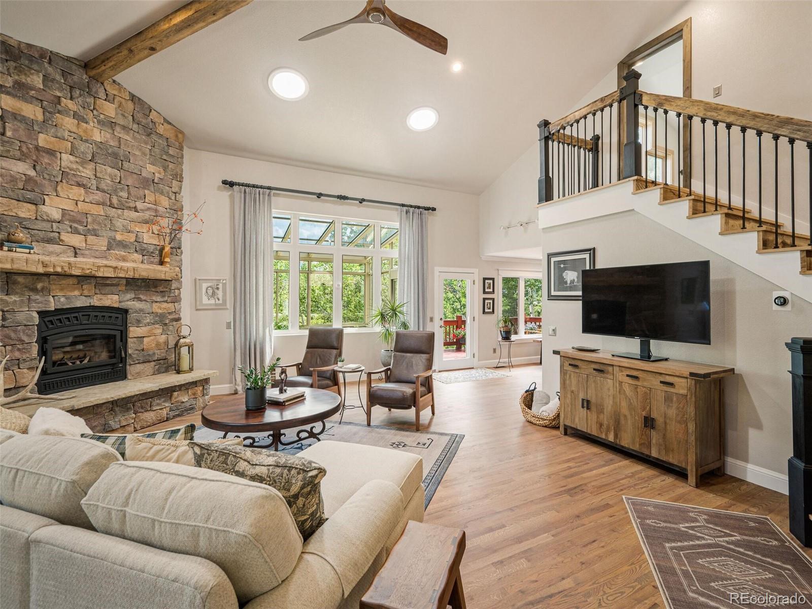 137 Nuthatch Road Evergreen, CO 80439 - Photo 15 of 50 a living room with furniture and a flat screen tv