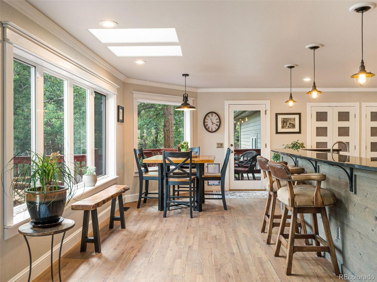 137 Nuthatch Road Evergreen, CO 80439 - Photo 17 of 50 a view of a dining room with furniture window and wooden floor