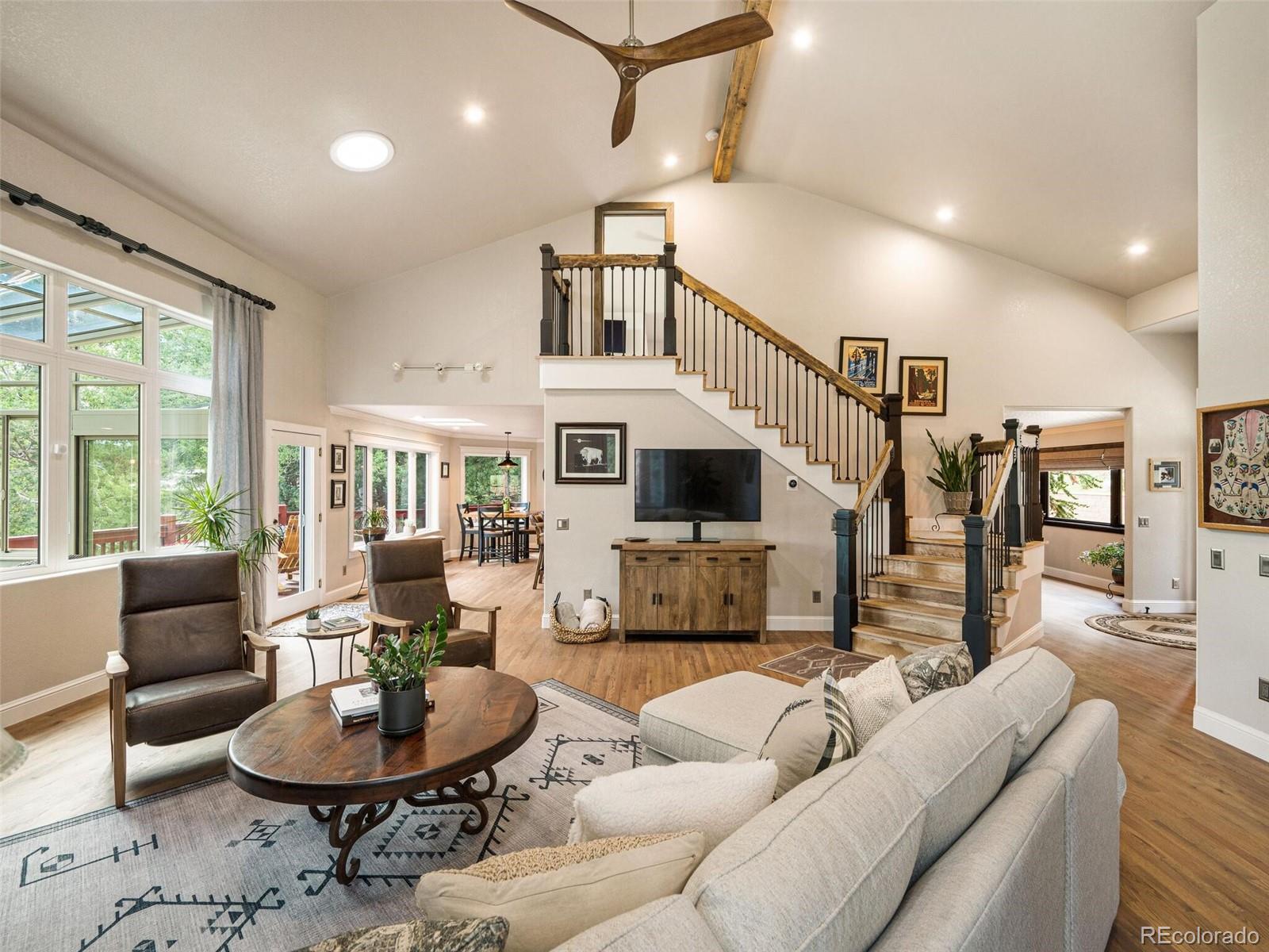 137 Nuthatch Road Evergreen, CO 80439 - Photo 2 of 50 a living room with furniture a fireplace and a large window