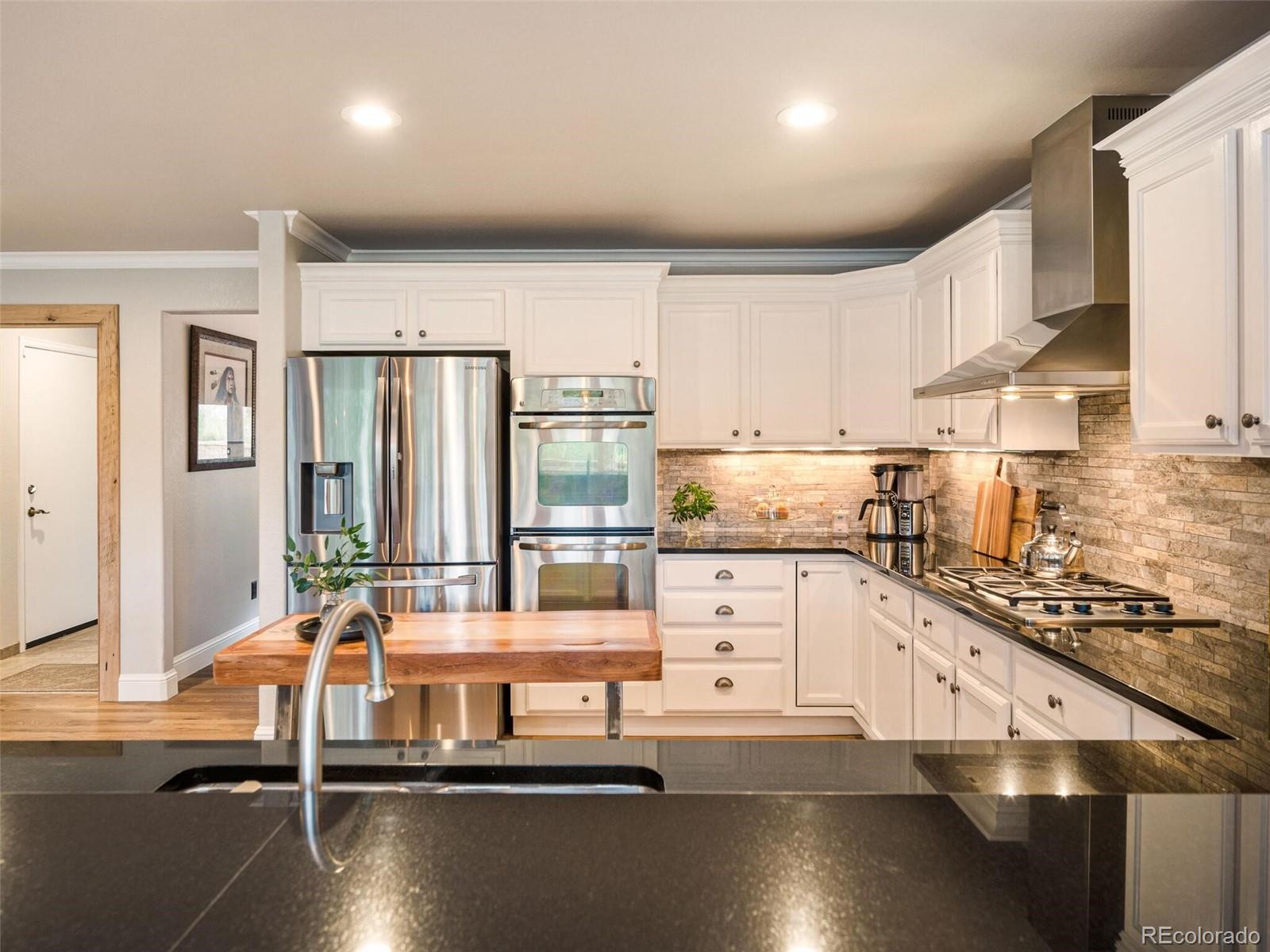 137 Nuthatch Road Evergreen, CO 80439 - Photo 21 of 50 a kitchen with counter top space and stainless steel appliances