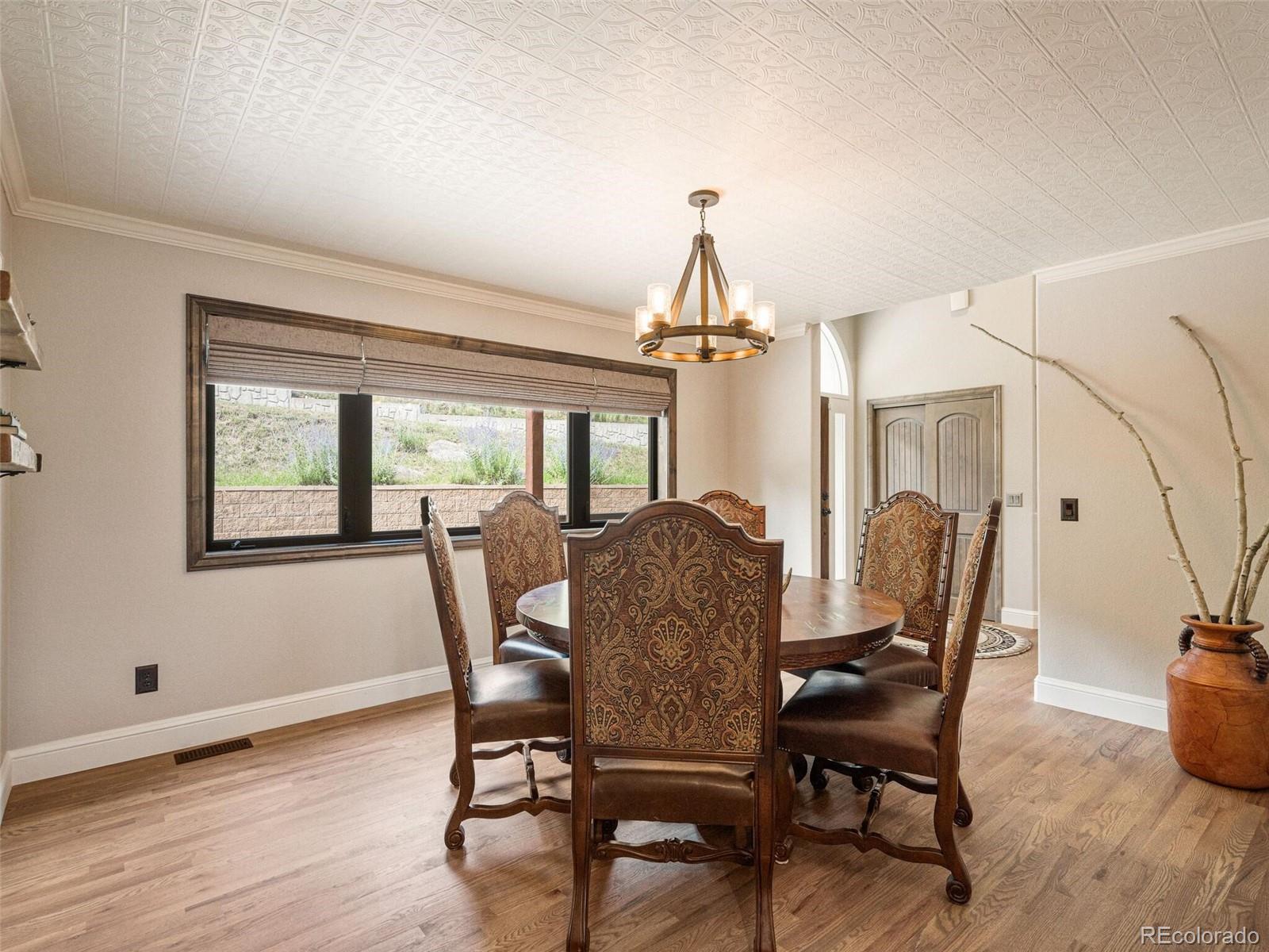 137 Nuthatch Road Evergreen, CO 80439 - Photo 25 of 50 a view of a dining room with furniture window and wooden floor