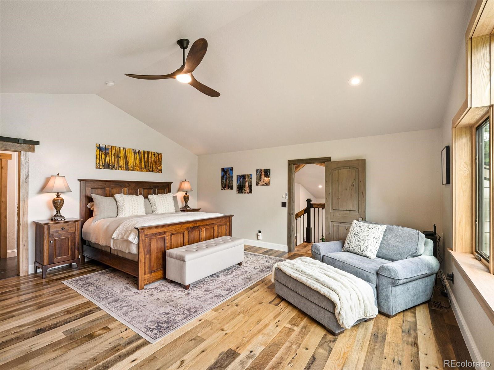 137 Nuthatch Road Evergreen, CO 80439 - Photo 27 of 50 a bedroom with a bed and wooden floor