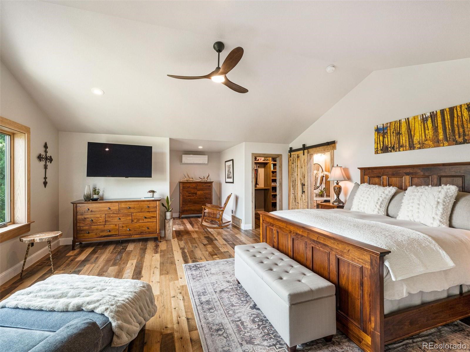 137 Nuthatch Road Evergreen, CO 80439 - Photo 28 of 50 a living room with a bed furniture and a flat screen tv
