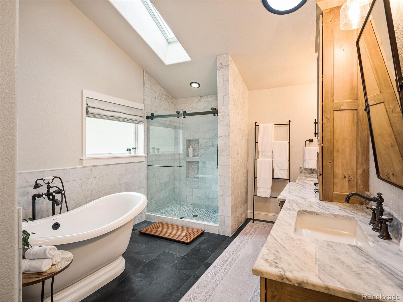 137 Nuthatch Road Evergreen, CO 80439 - Photo 29 of 50 a bathroom with a granite countertop sink and a mirror