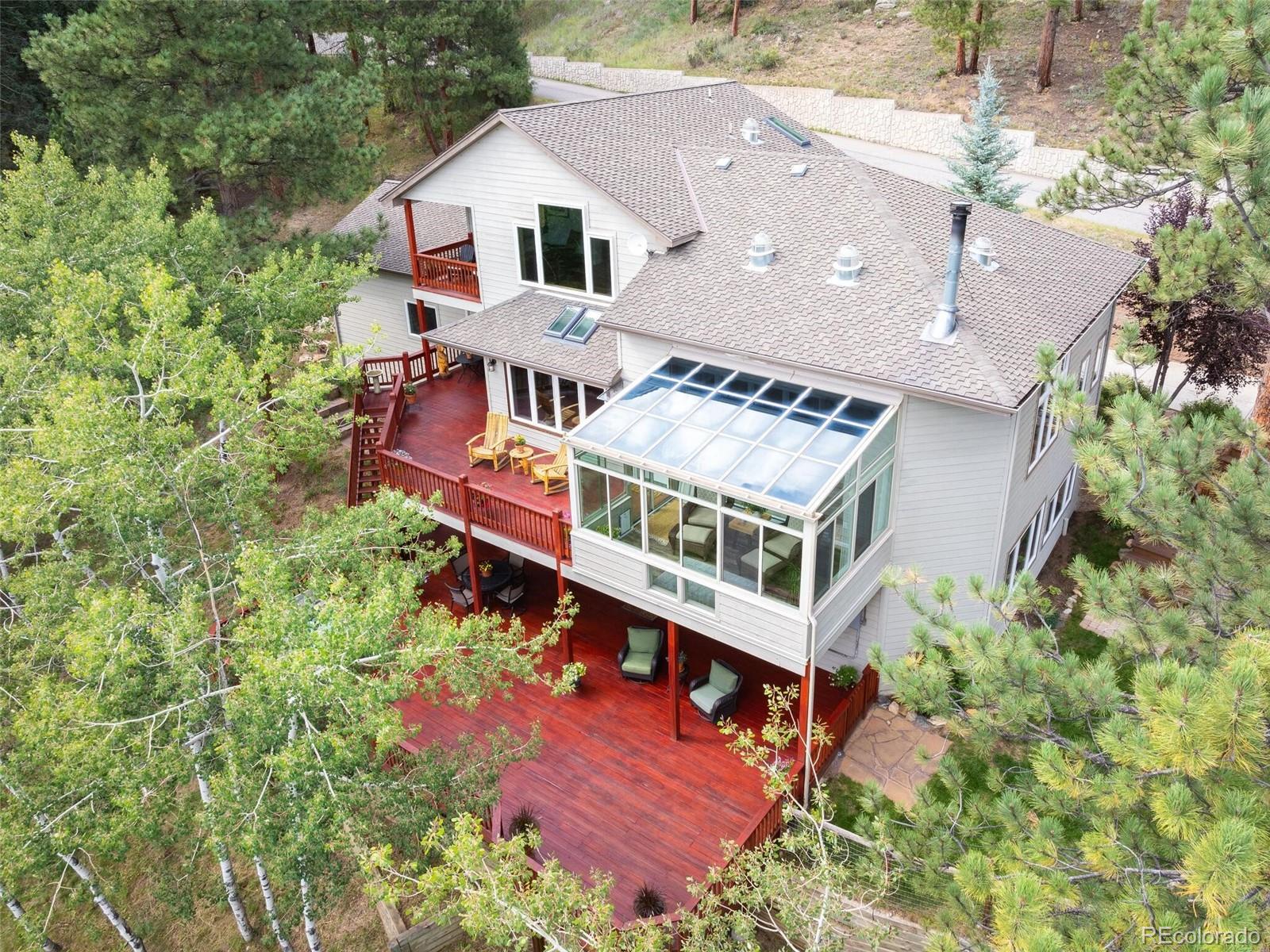 137 Nuthatch Road Evergreen, CO 80439 - Photo 3 of 50 an aerial view of a house with balcony and trees al around