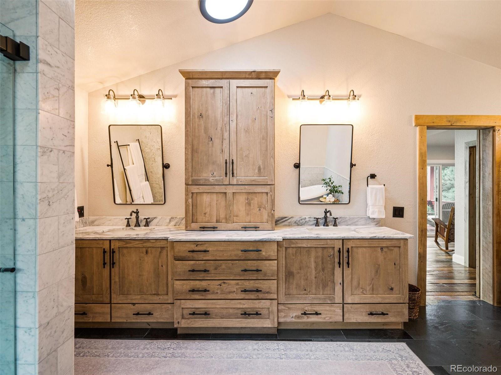 137 Nuthatch Road Evergreen, CO 80439 - Photo 31 of 50 a bathroom with a double vanity sink mirror and