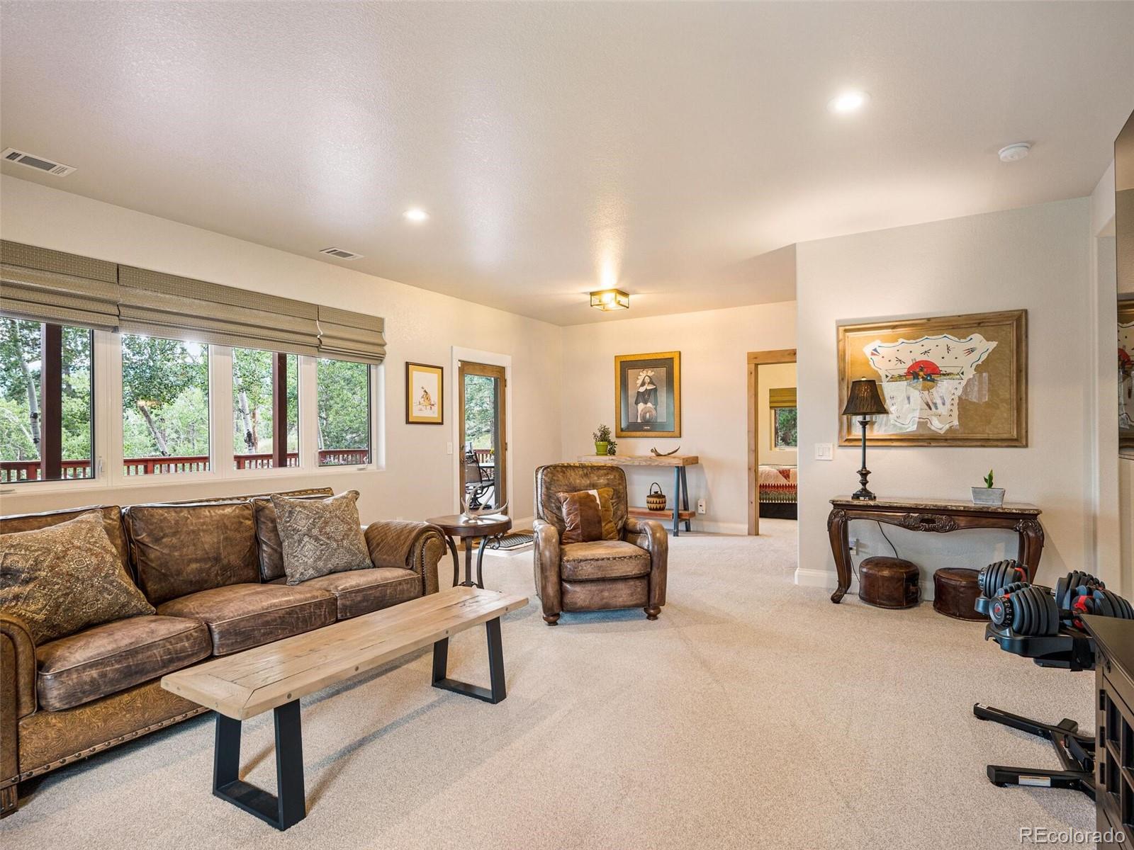 137 Nuthatch Road Evergreen, CO 80439 - Photo 34 of 50 a living room with furniture and a flat screen tv