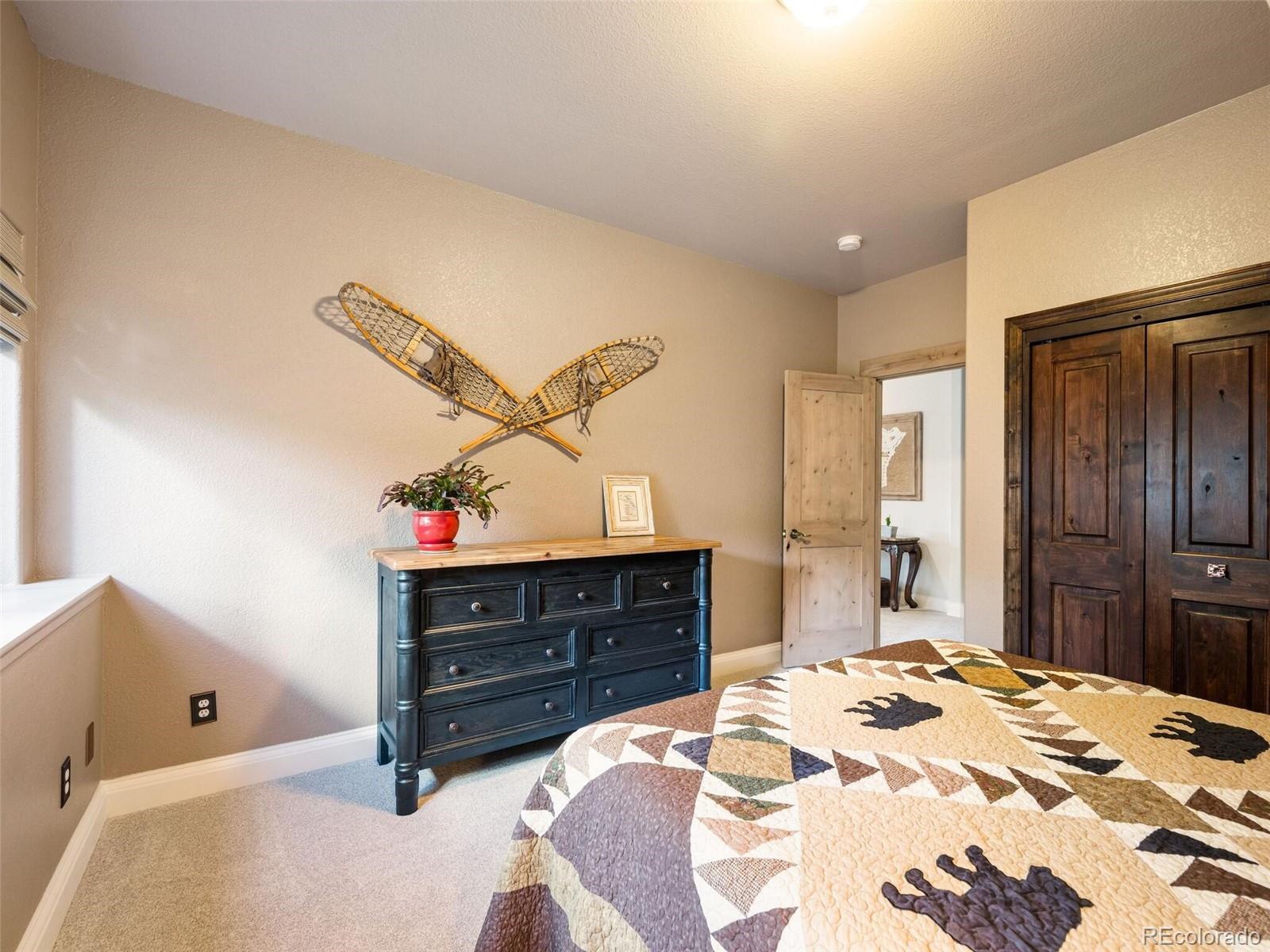 137 Nuthatch Road Evergreen, CO 80439 - Photo 37 of 50 a bed room with a bed and a dresser