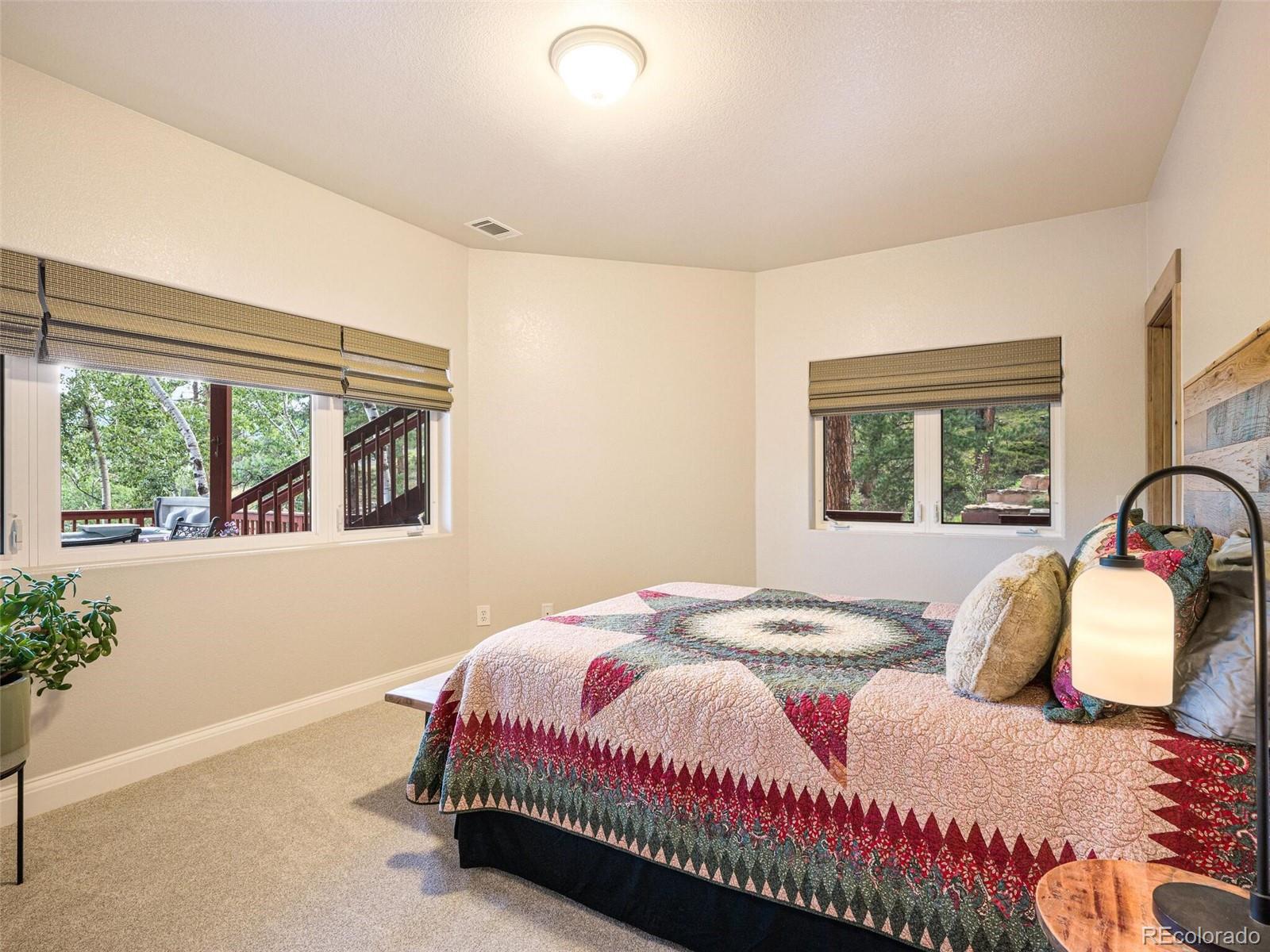 137 Nuthatch Road Evergreen, CO 80439 - Photo 38 of 50 a bedroom with a bed and a large window