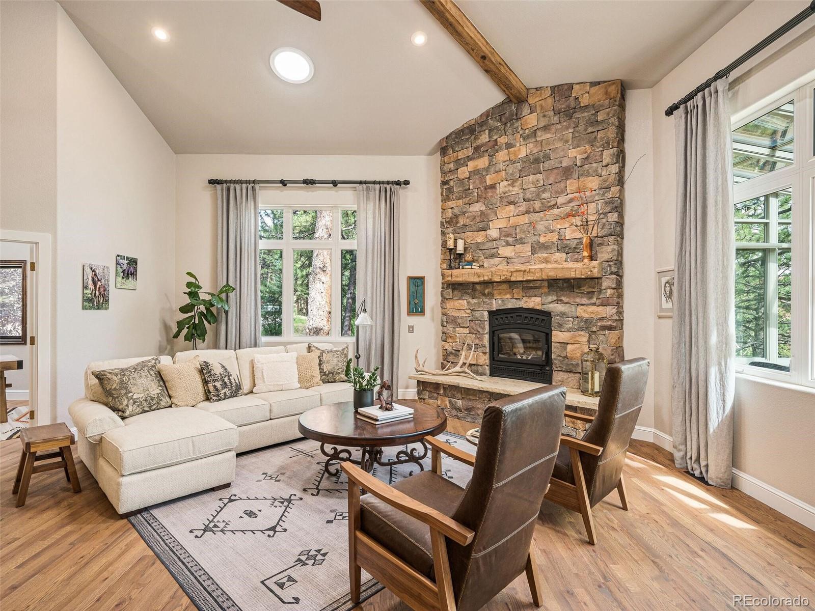 137 Nuthatch Road Evergreen, CO 80439 - Photo 4 of 50 a living room with furniture and a fireplace