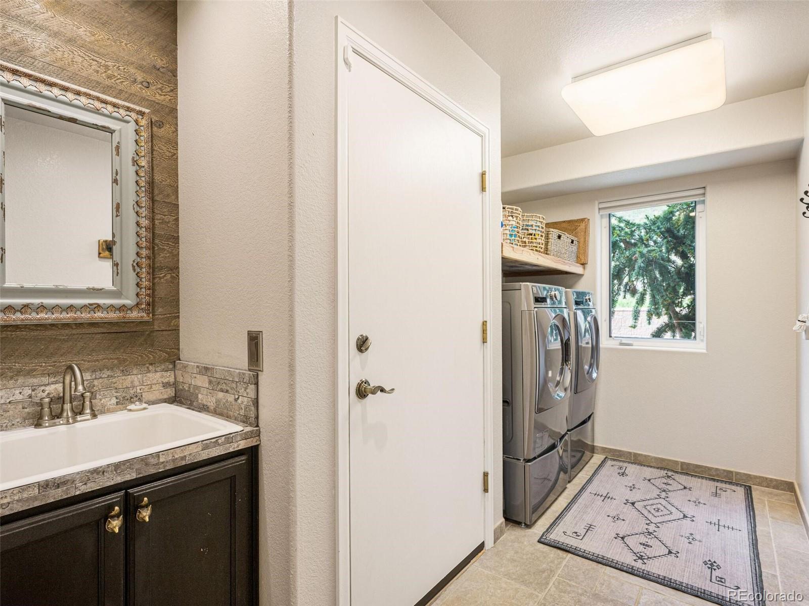 137 Nuthatch Road Evergreen, CO 80439 - Photo 41 of 50 a bathroom with a sink a washer and dryer