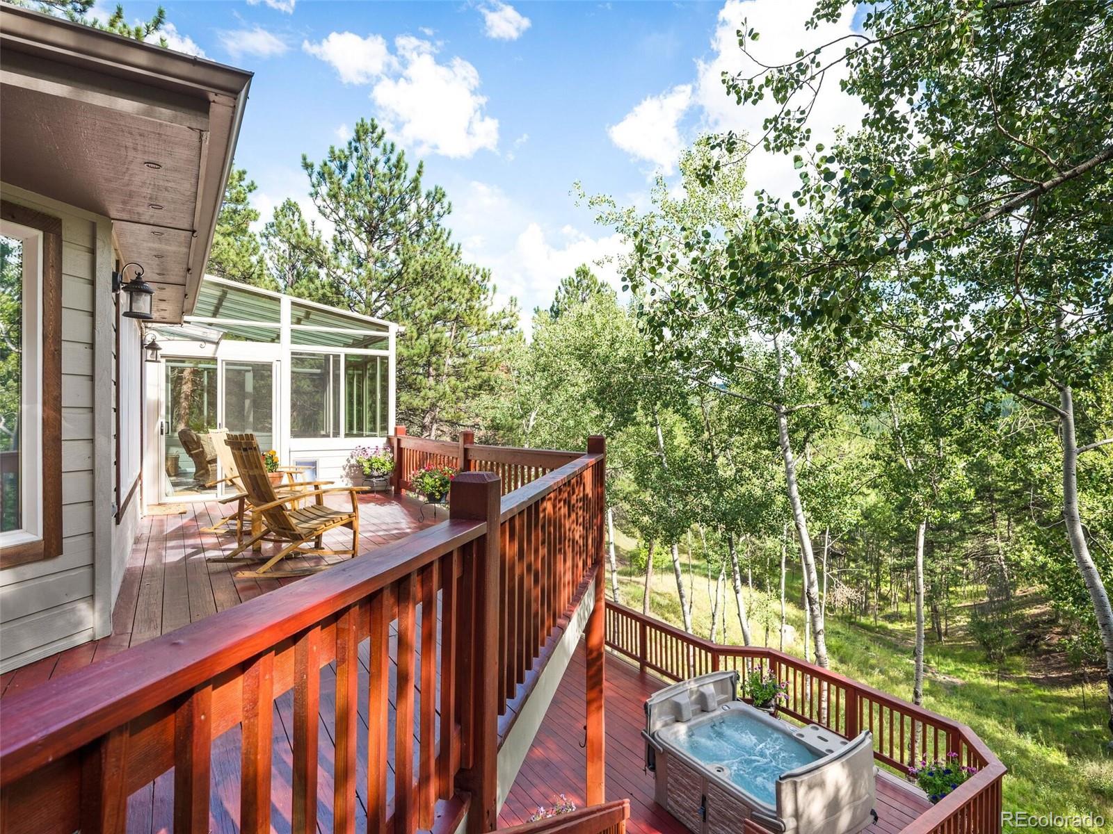 137 Nuthatch Road Evergreen, CO 80439 - Photo 45 of 50 a balcony with wooden floor and outdoor seating