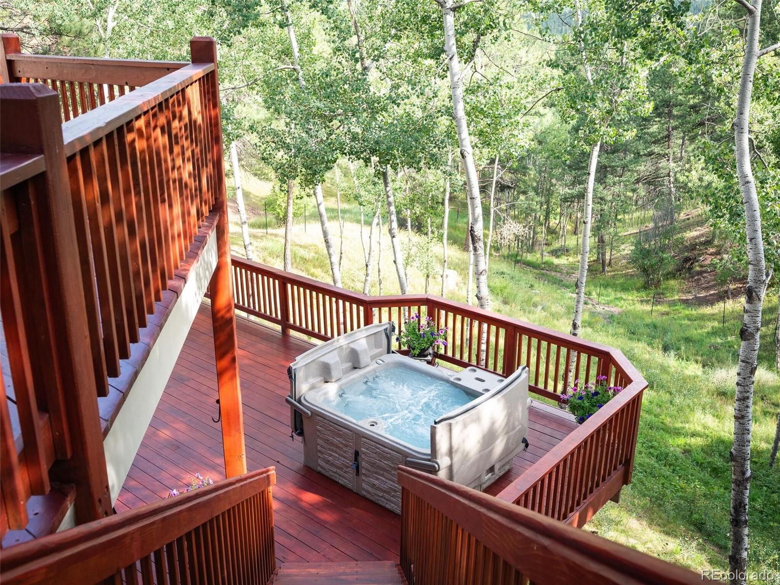 137 Nuthatch Road Evergreen, CO 80439 - Photo 47 of 50 a view of deck with wooden floor and outdoor seating