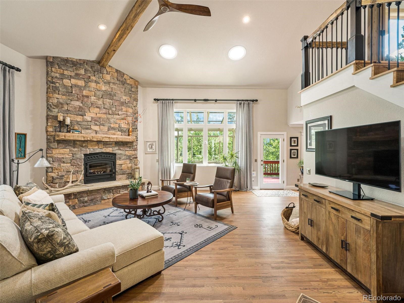 137 Nuthatch Road Evergreen, CO 80439 - Photo 9 of 50 a living room with furniture and a flat screen tv