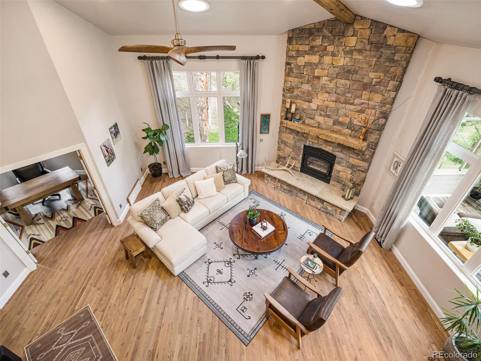 137 Nuthatch Road Evergreen, CO 80439 - Photo 10 of 50 a view of living room with furniture and a fireplace