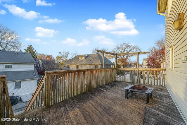 a balcony with wooden floor and city view