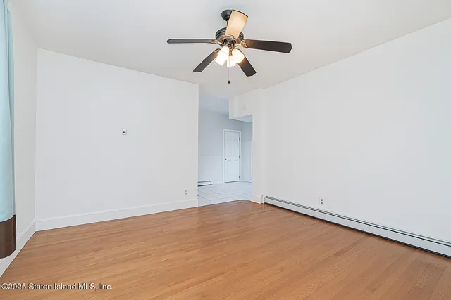 a view of room with window and wooden floor