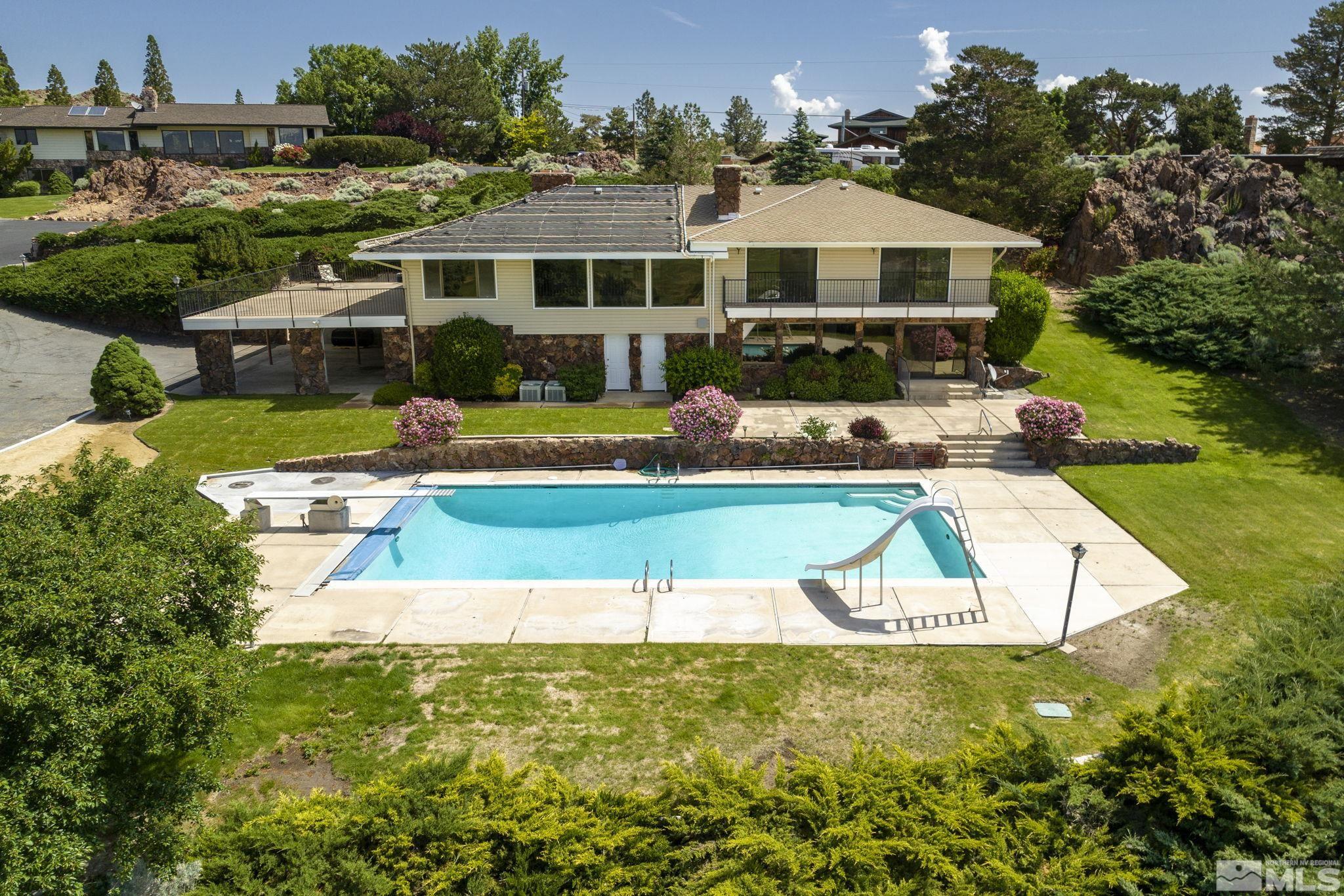 a aerial view of a house with a swimming pool patio and lake view