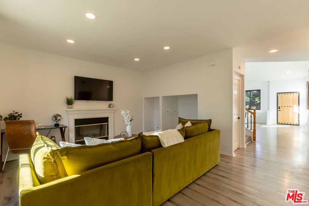18404 Arminta Street Reseda, CA 91335 - Photo 11 of 33 a living room with furniture and a flat screen tv