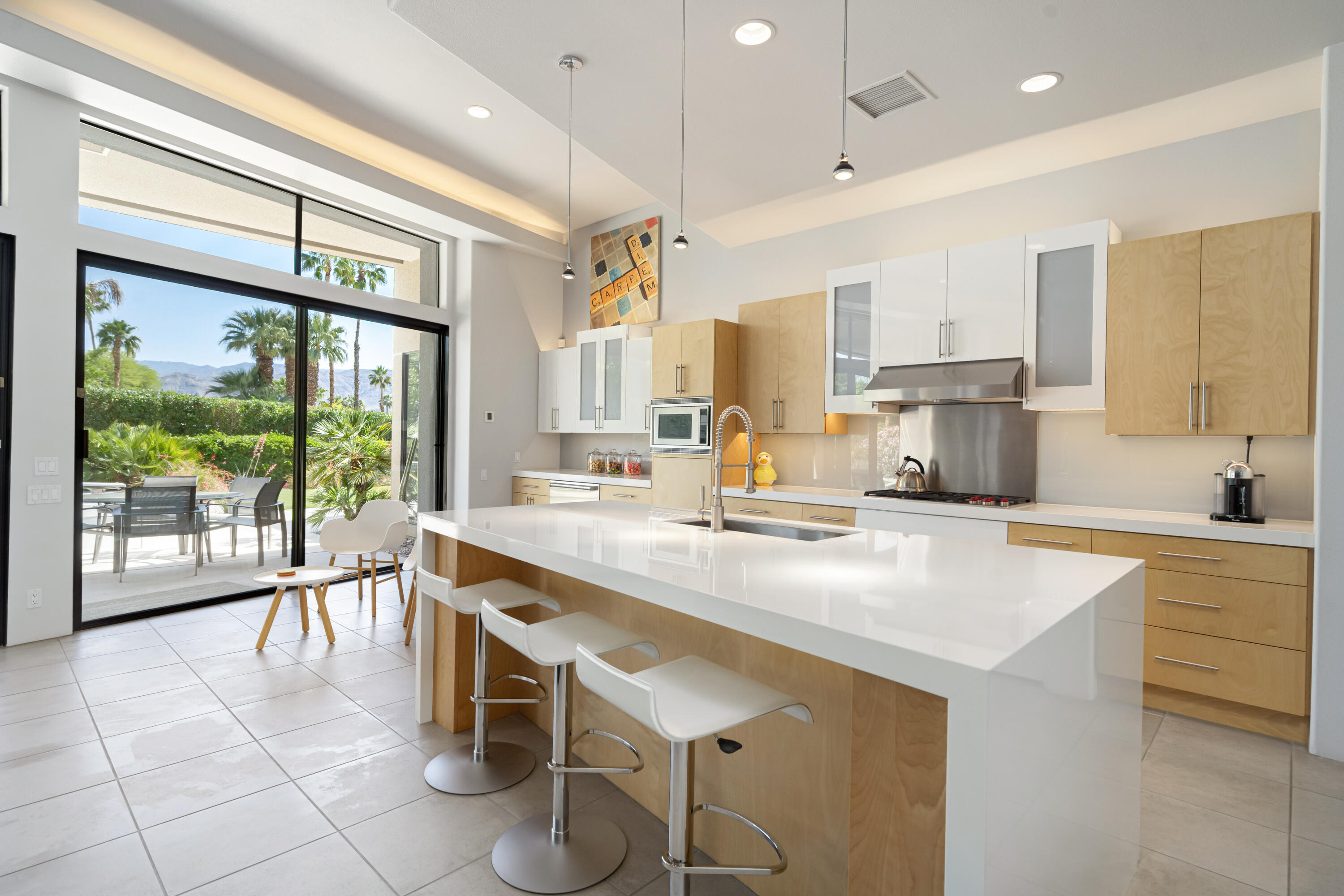18 Boulder Lane Rancho Mirage, CA 92270 - Photo 14 of 41 a kitchen with a table chairs sink and cabinets