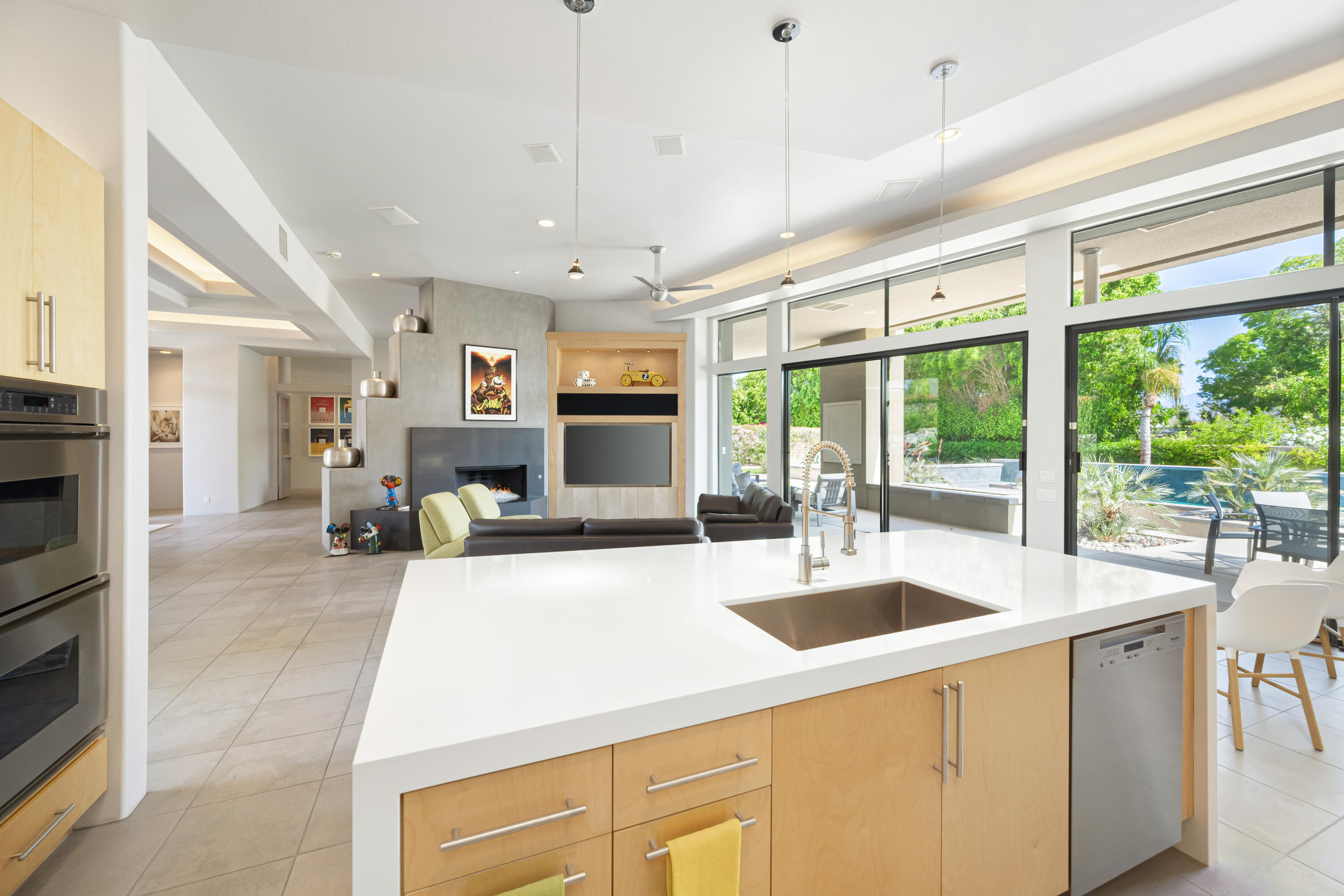 18 Boulder Lane Rancho Mirage, CA 92270 - Photo 15 of 41 a large kitchen with kitchen island a large window cabinets a sink and stainless steel appliances