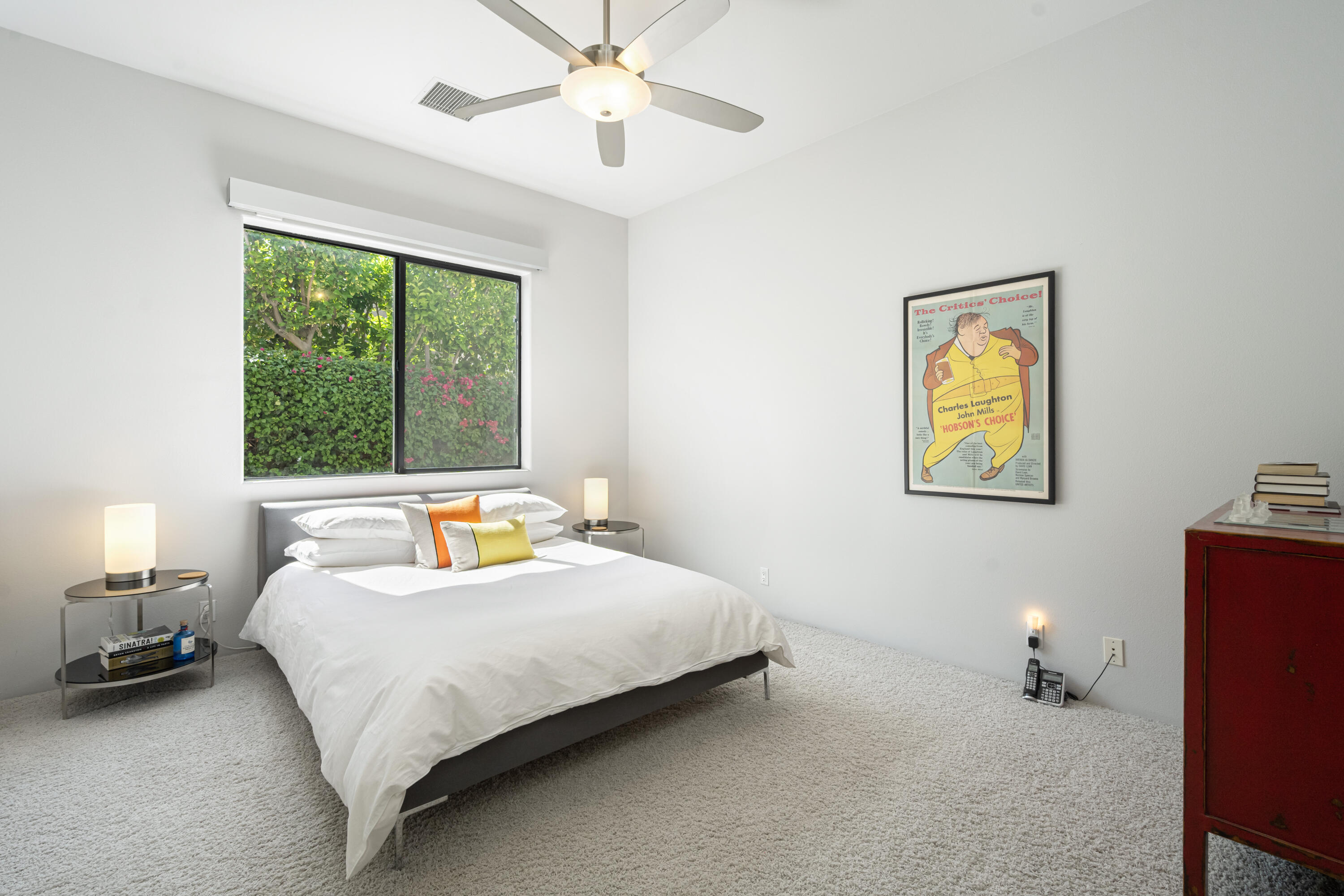 18 Boulder Lane Rancho Mirage, CA 92270 - Photo 26 of 41 a bedroom with a bed and a chandelier