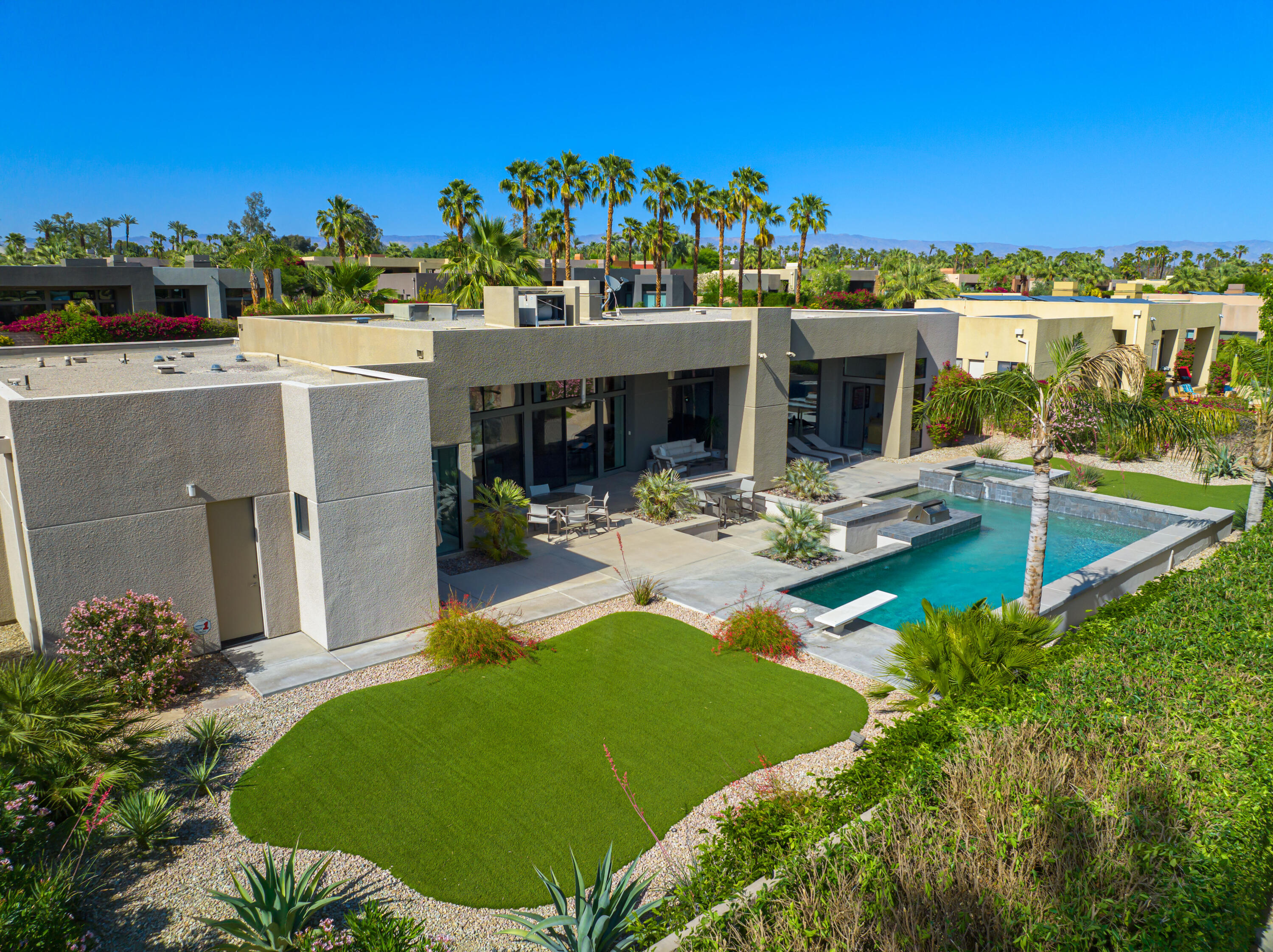 18 Boulder Lane Rancho Mirage, CA 92270 - Photo 39 of 41 a view of a house with pool and chairs