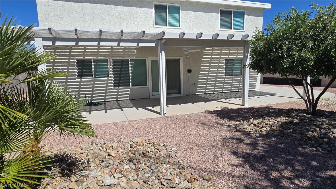 3849 Reflection Way Las Vegas, NV 89147 - Photo 25 of 25 Relax and unwind on this spacious covered patio, offering comfortable outdoor living and low-maintenance landscaping.