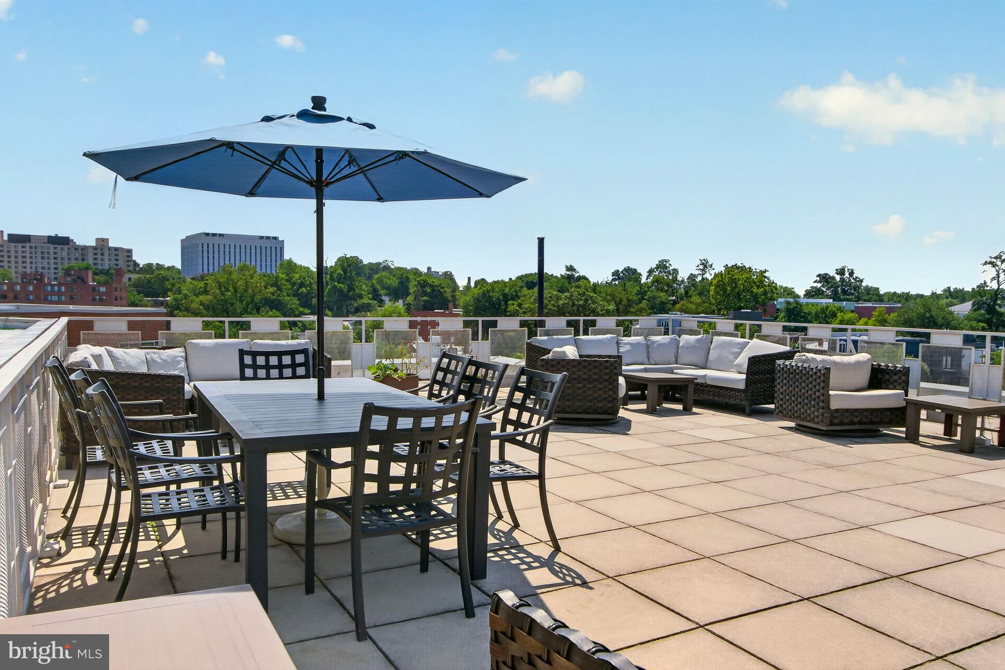 4000 Tunlaw Road Northwest, Unit 705 Washington, DC 20007 - Photo 34 of 44 a view of a terrace with furniture and umbrella