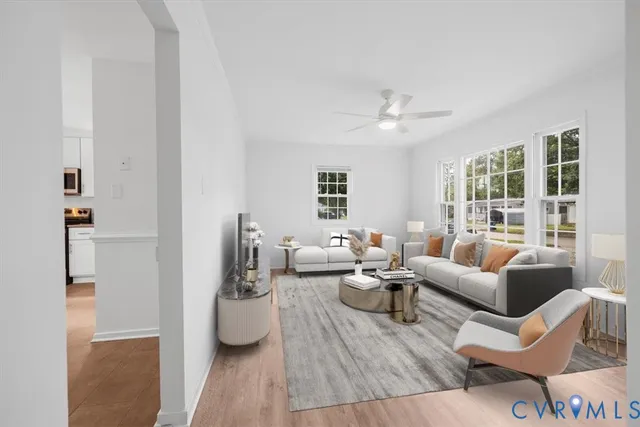 a living room with furniture and wooden floor
