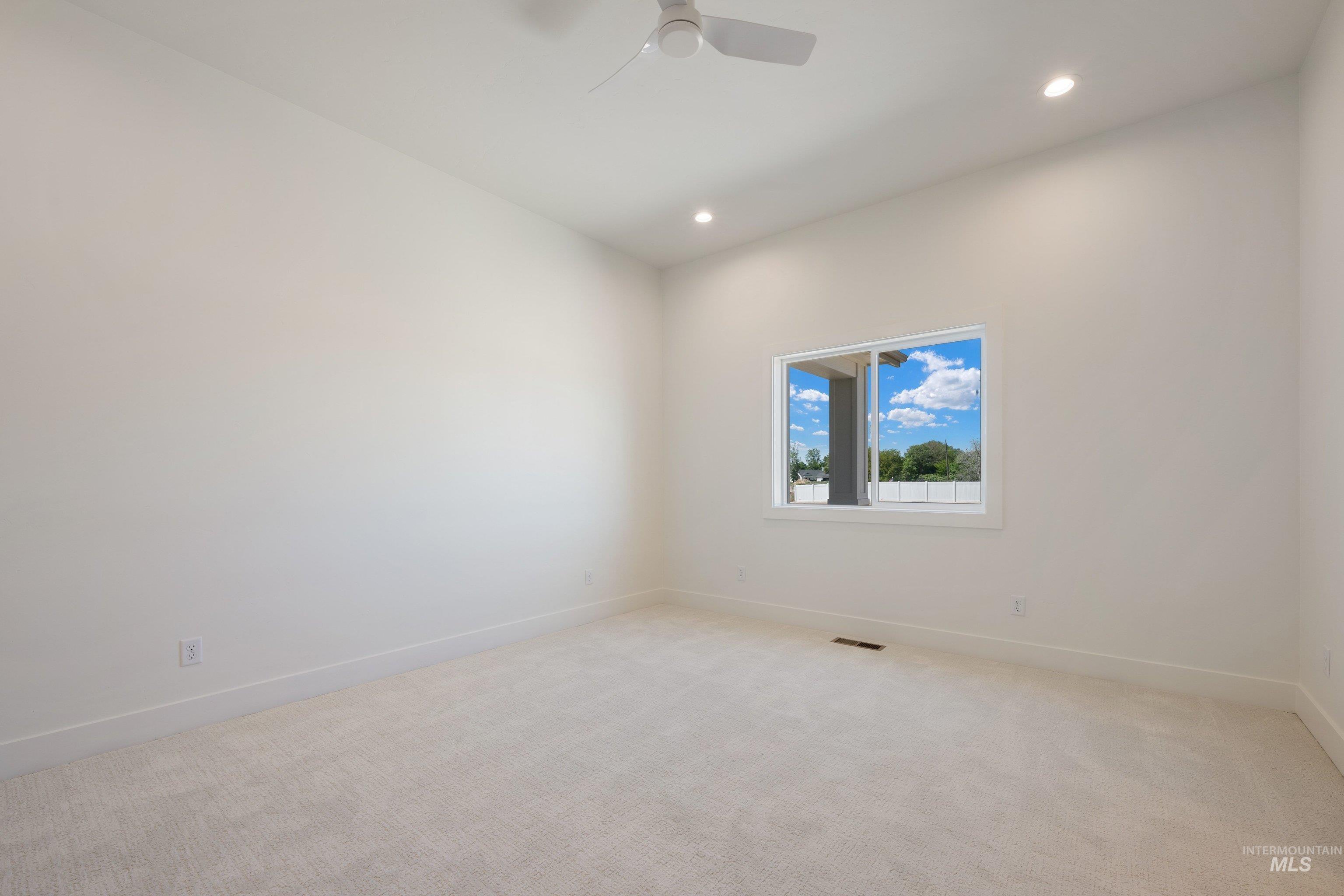 24821 Ardmore Court Caldwell, ID 83607 - Photo 30 of 43 Bright room featuring plush carpeting, recessed lighting, and a modern ceiling fan