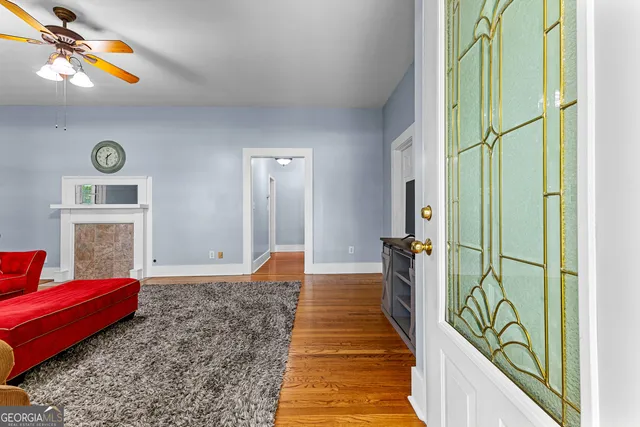 a bedroom with a bed and painting on the wall