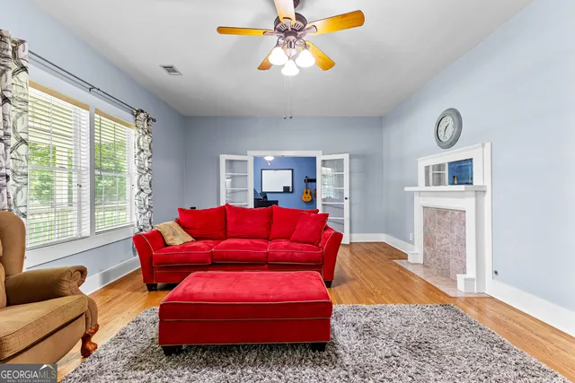 a living room with furniture and wooden floor
